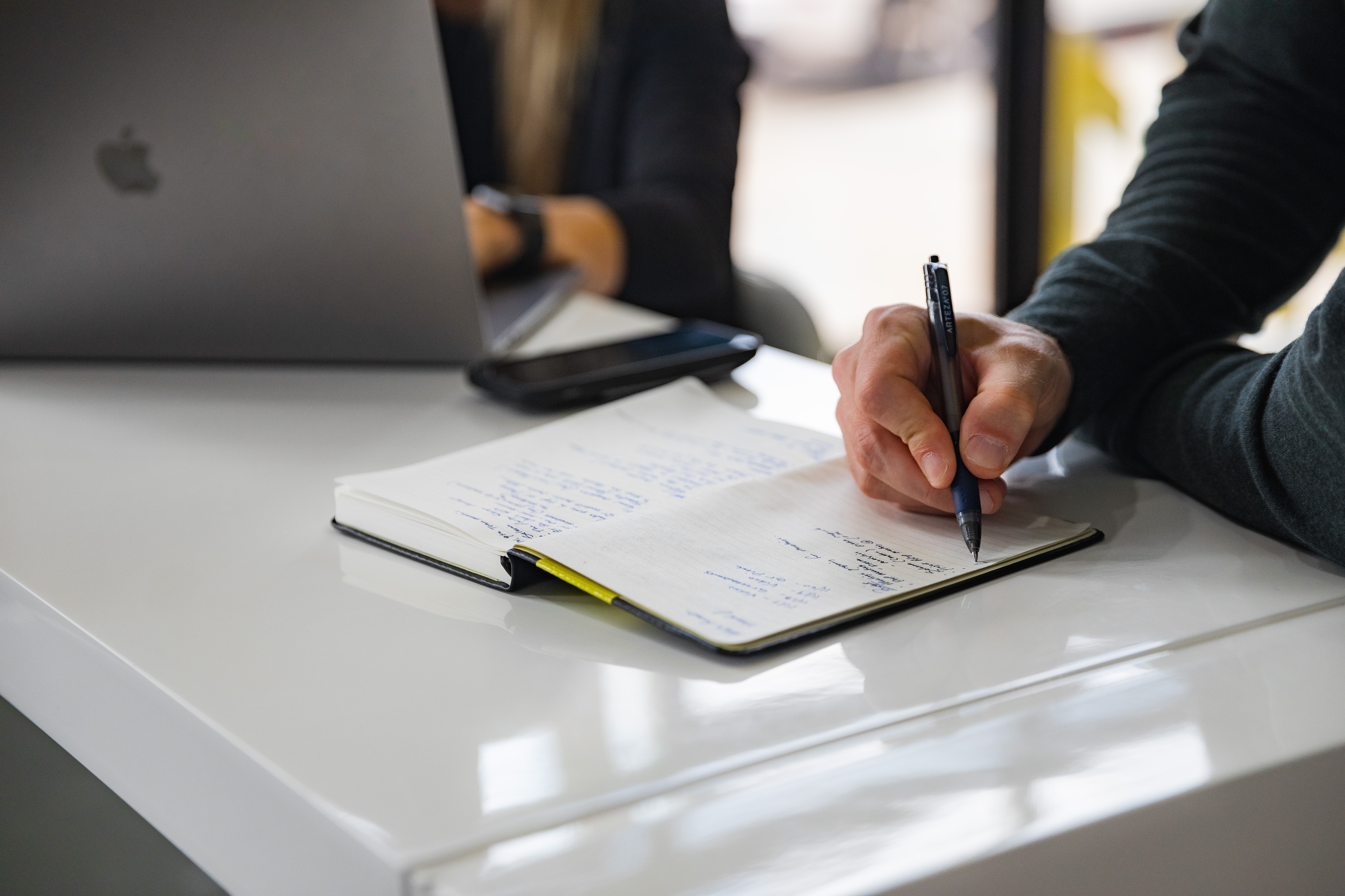 A picture of a person taking board meeting minutes