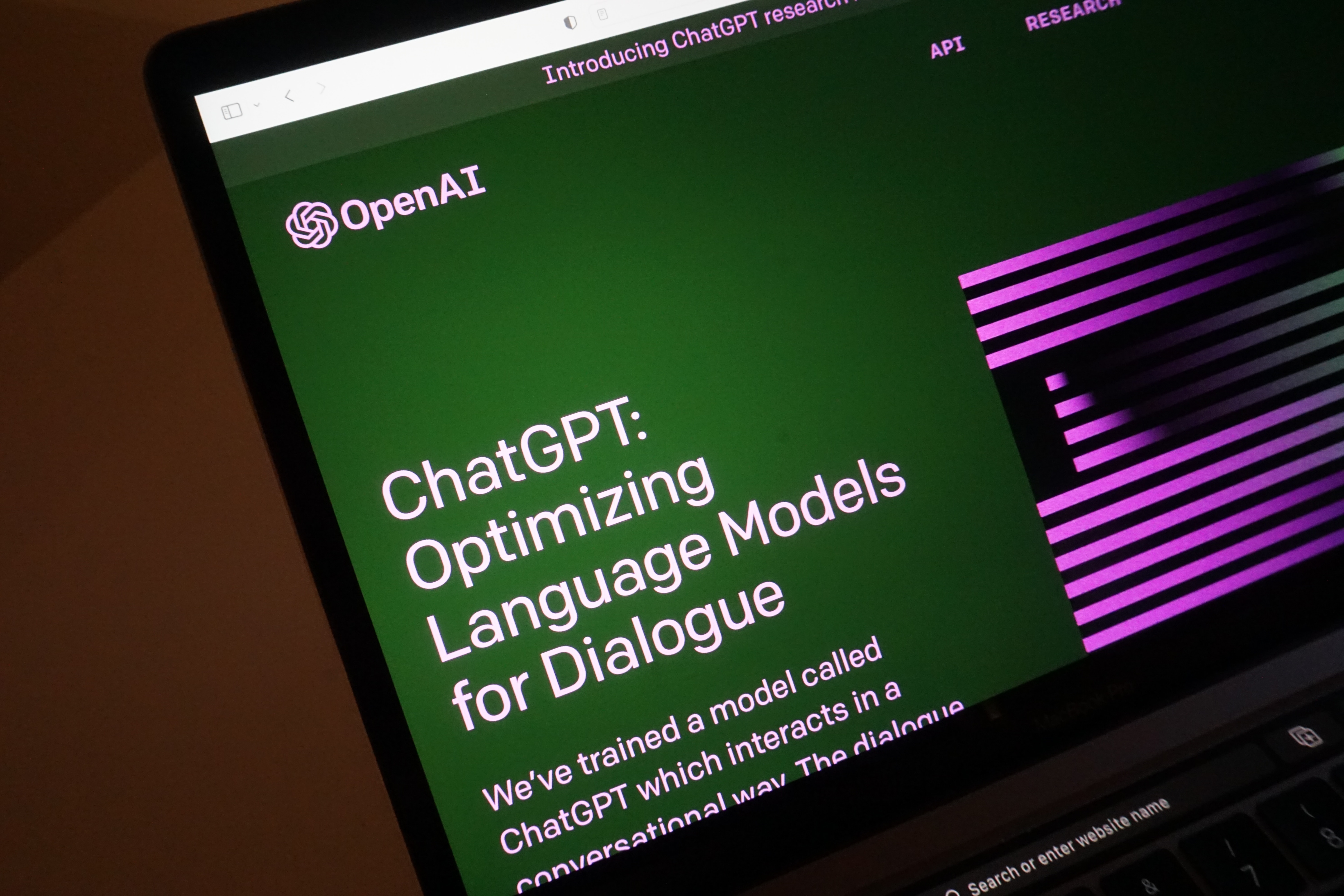 A picture showcasing the website of OpenAI, where information in regard to ChatGPT is displayed.