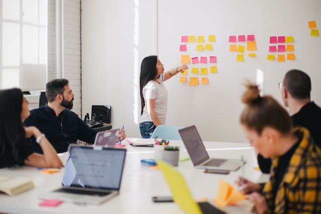 Meeting in which one person is showing something on the white board 