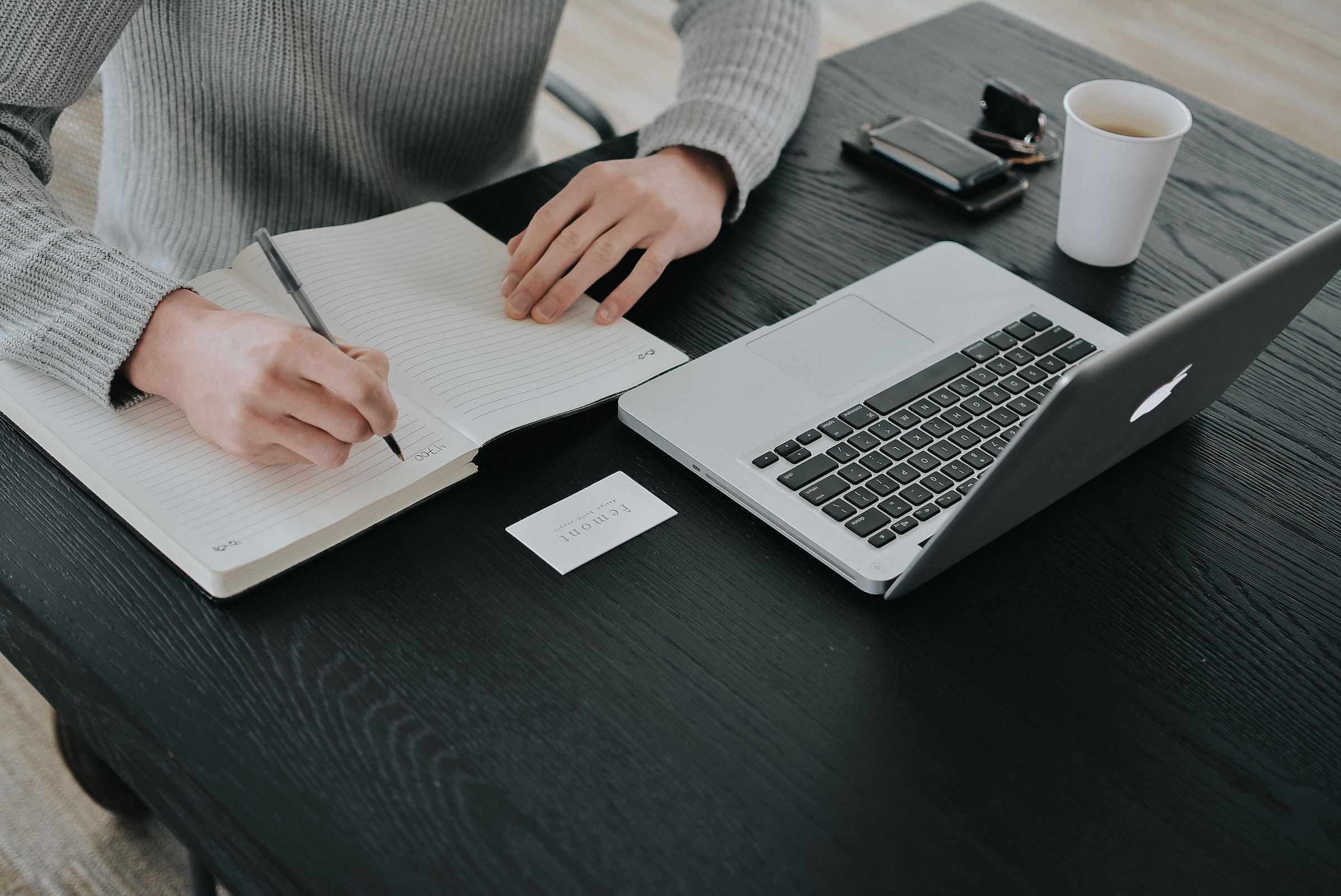 This is an image of a person creating and reviewing action items after a successful meeting.