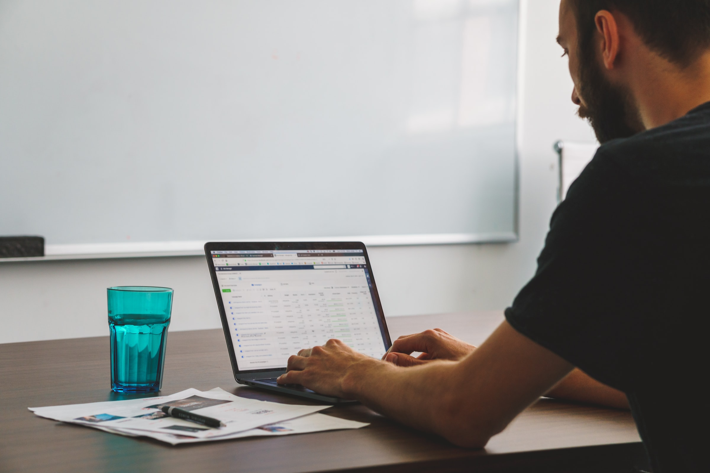 This is an image showing a man working on his mac