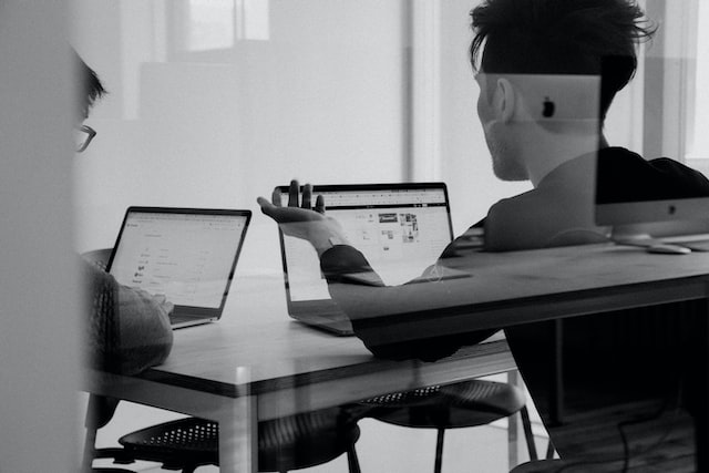 Two people giving each other feedback