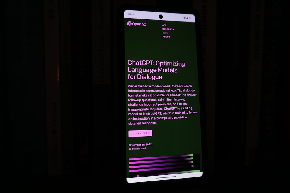 a cell phone with a lit up screen in the dark with CHATGPT
