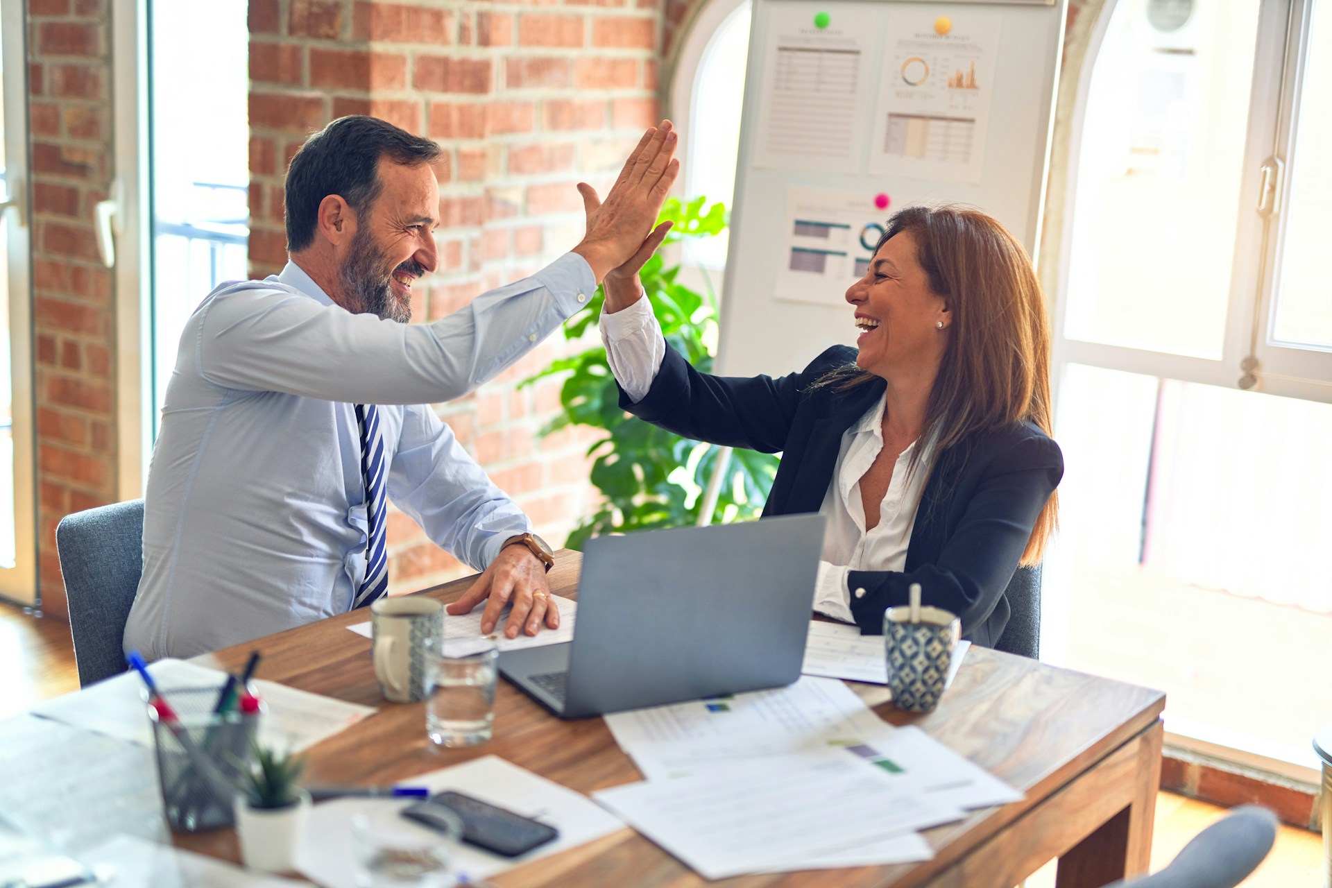 man and women giving high five for great introduction, how to introduce yourself to a new team