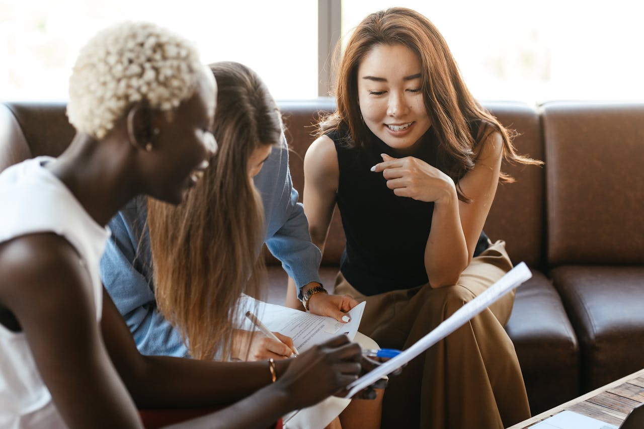 women taking meeting notes